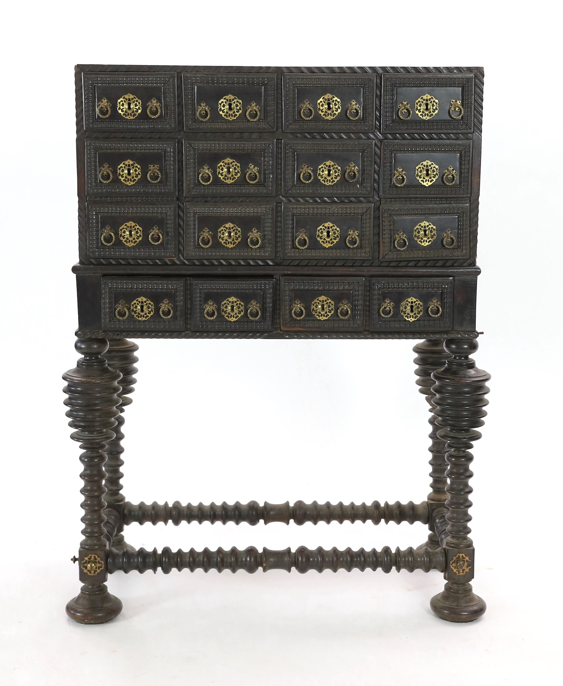 A 17th century Portuguese brass mounted ebonised rosewood Contador on stand Width 105cm. Height 136cm. Depth 50cm.